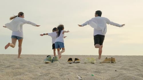 Back View of Family Parents with Children Fun Holding Hands Together Running to Beach in Holiday Dad