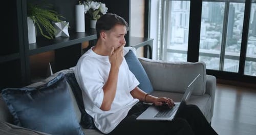 Man Working from Home is Frustrated with Laptop