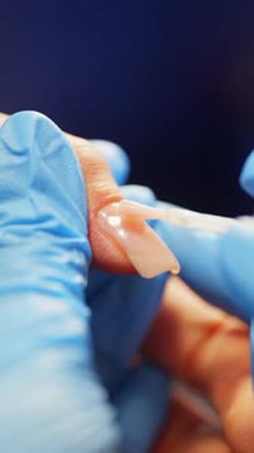 Nail Technician Applying Acrylic to a Fingernail