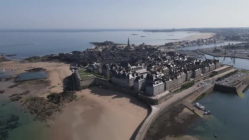 Fortified old town of Saint-Malo and Plage du mole or pier beach during low tide, Brittany in France