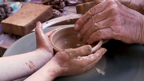 Hands Shaping Clay on Pottery Wheel