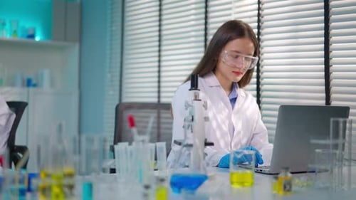 Asian female scientist working in biotechnology research laboratory.