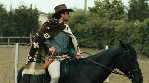 Cowboy with Revolver on Horseback in Rural Setting