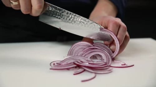 Slicing a Red Onion on Cutting Board