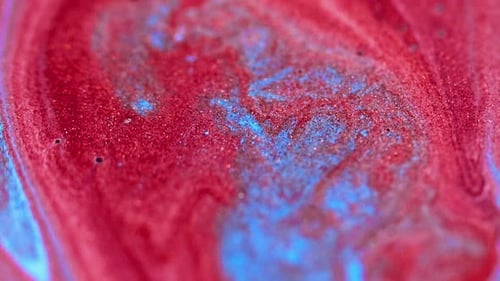 Abstract Red and Blue Liquids Mixing Close Up