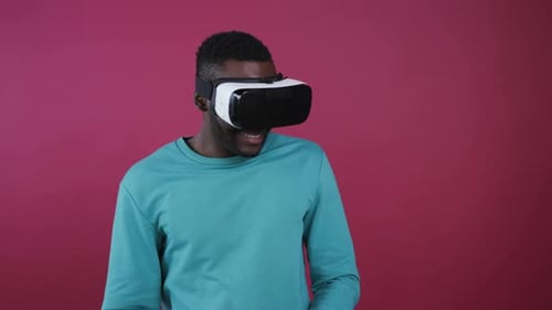 Man using VR headset in front of backdrop