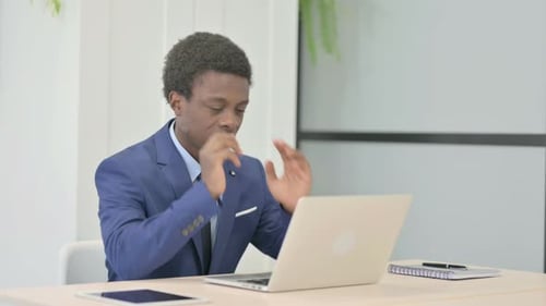 Young Adult Experiencing Headache at Office Desk