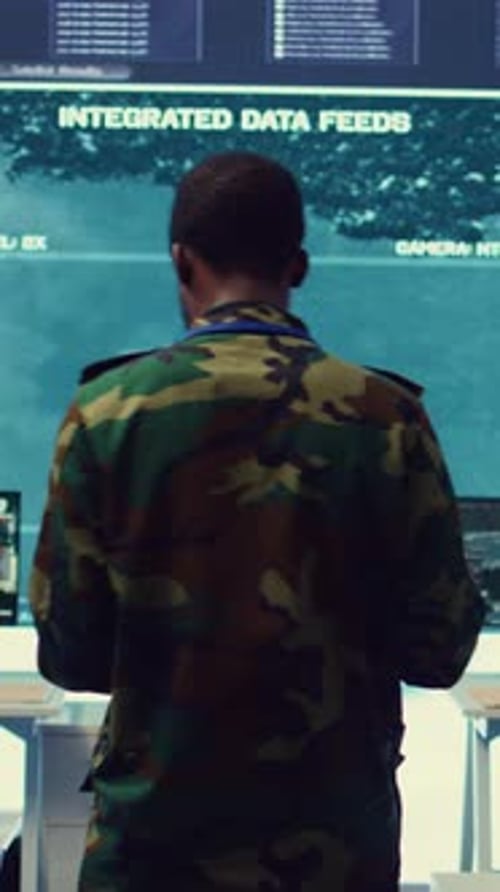 Man in Camouflage Using Laptop in Tech Workplace