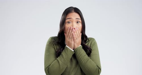 Wow, wtf and hands on woman face in studio for fake news, drama or gossip on white background