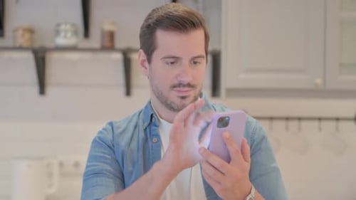 Man Using Smartphone in Modern Home