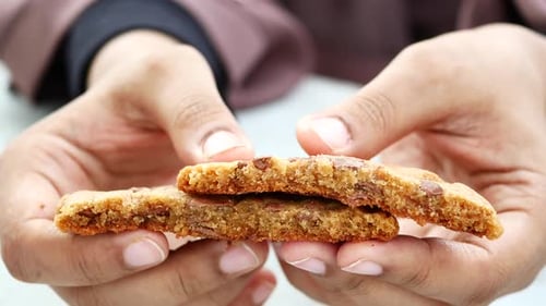 Women Breaking Sweet Cookies Close Up