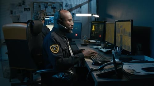 Black Man Working As Dispatcher at Police Station Picking Up Phone