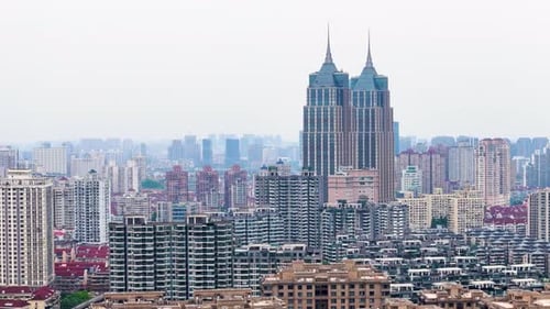 Slow orbiting drone shot of Skyscraper buildings, river, and cityscape in Shanghai, China