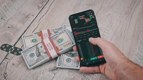 Trader Analyzes Ethereum Cryptocurrency Prices on Smartphone Above Dollars