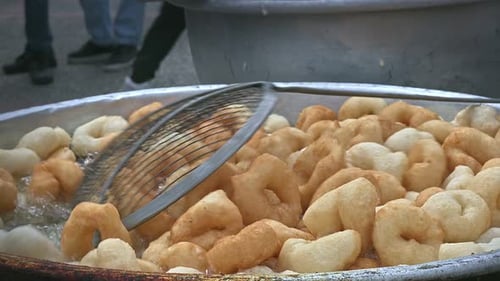 Street Cook Frying Traditional Sweet Lokma in Turkey.