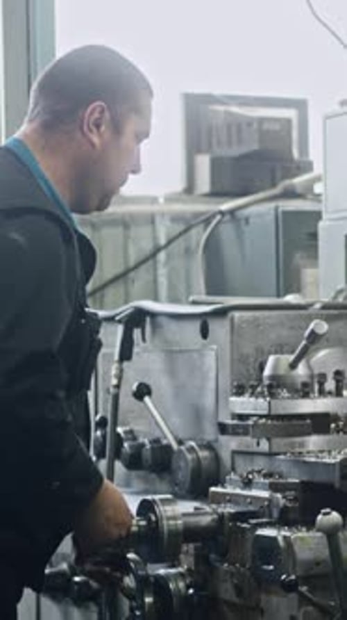 Man Operating Machine in Factory Setting