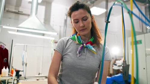 Woman Spot Cleaning Garment With Industrial Machine