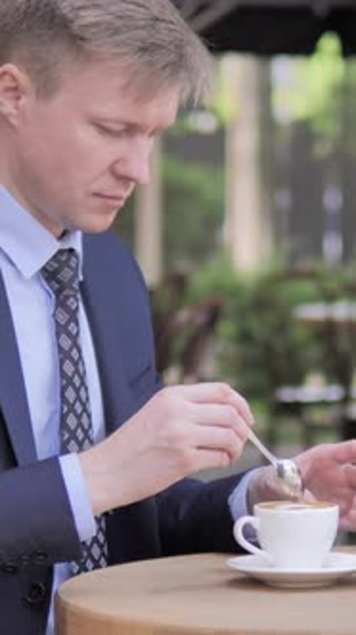 Businessman Drinking Coffee while Sitting in Outdoor Cafe, Vertical Video