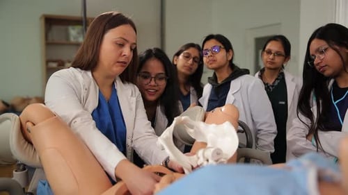 Medical Professionals Observe Simulated Birthing Process in Classroom