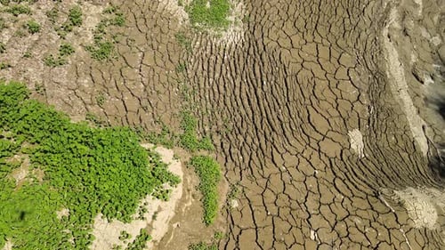 Dry Cracked Earth and Sparse Vegetation Aerial View