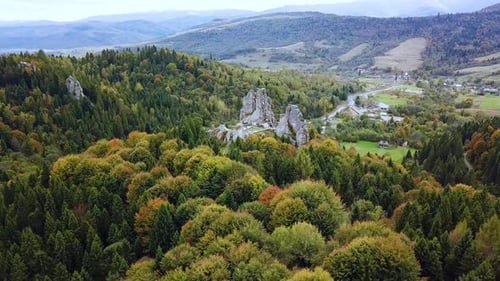 Drohnenaufnahme aus der Luft, große Felsen im Herbstwald, Baumkronen, Pinien, Schönheit der Natur. Filmmaterial
