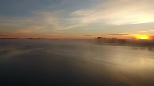 Colorful sunrise over still Powell lake, Florida.