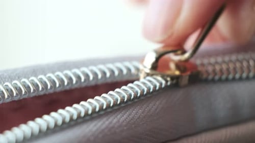 Close Up Hand Woman in Motion Action Open Zip