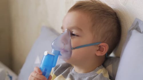 Little 2 Years Old Boy Does Therapeutic Inhalation Using a Nebulizer