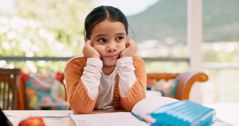 Sad, bored and a thinking child with homework, studying depression or ...