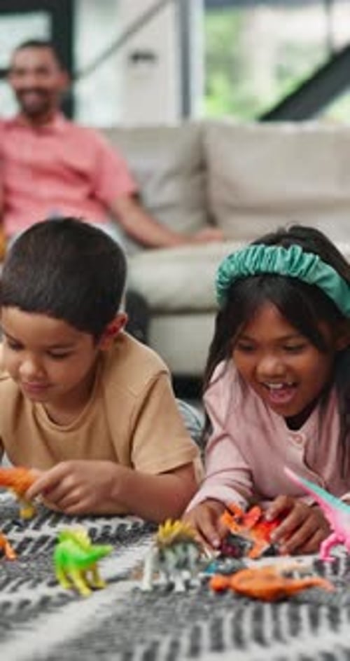 Children Playing With Toy Dinosaurs on Floor
