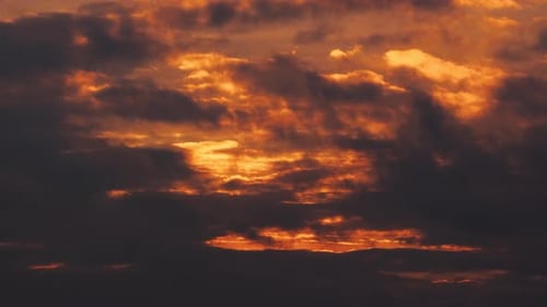 Golden Light Illuminates Dramatic Clouds During Sunrise