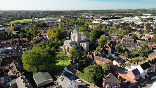a chirch locatted atop a hill at the center of a small countryside town