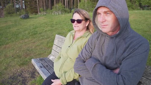 Couple Relaxing on Park Bench at Sunset