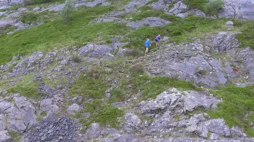 Couple climbing a mountain aerial shot