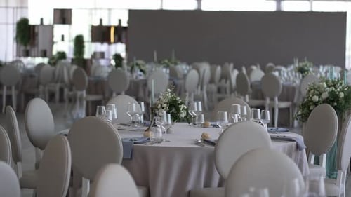 elegant wedding reception hall with round tables and floral decor