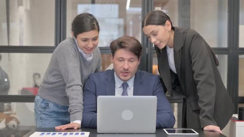 Colleagues Collaborate on Video Call in Office