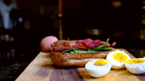 Breakfast Sandwich with Boiled Eggs on Cutting Board