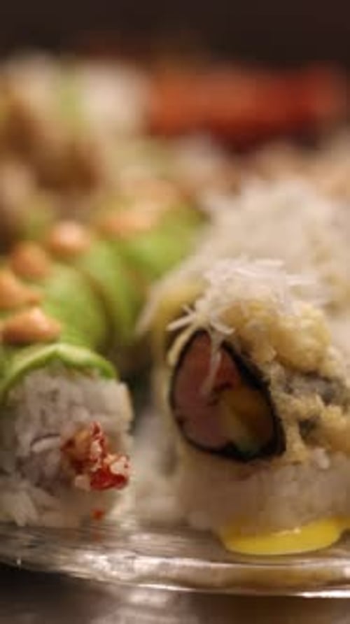 a set of sushi on a silver background, overhead view