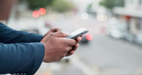Person, phone and hands in city for communication, social media or outdoor networking on a balcony