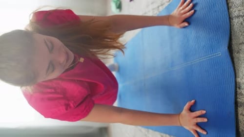 Young Woman Working Out on Yoga Mat at Home