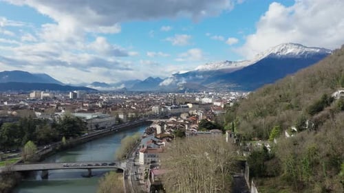 Panoramic View of Grenoble Featuring the Isere River Urban Landscape and Snow Capped Mountains in