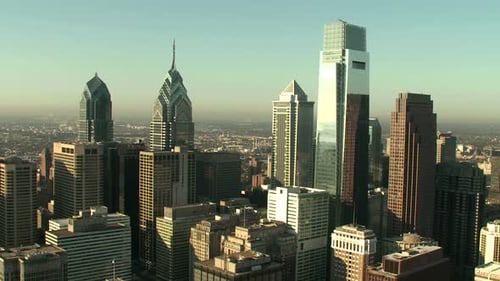 Synergy Collection: An aerial follow shot of skyscraper during daytime in city