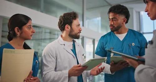 Doctor, tablet and team discussion in hospital for surgery schedule, task delegation or planning