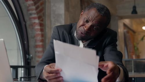 African American Business Man Arguing Phone with Laptop Papers Businessman in Office Irritated Male