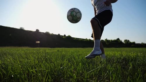 Sportsman Juggling Soccer Ball on Stadium at Sunny Day Young Man Kicking Ball at Green Field