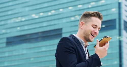 A young businessman talking on a cellphone in the city