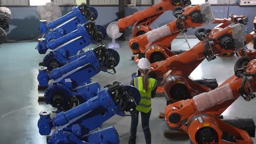 Female engineer at factory. Smart Industry Robot Arms Modernization for Digital Factory Technology