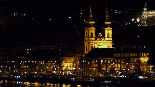 Budapest city (Hungary capital) center view with illuminated church tower and Danube river at night,