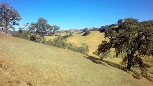 Drone View of Gorgeous Mountainside Landscape Under Blue Sky Above