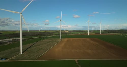Large White Power Generators That Generate Electricity From the Wind Wind Turbines in a Field